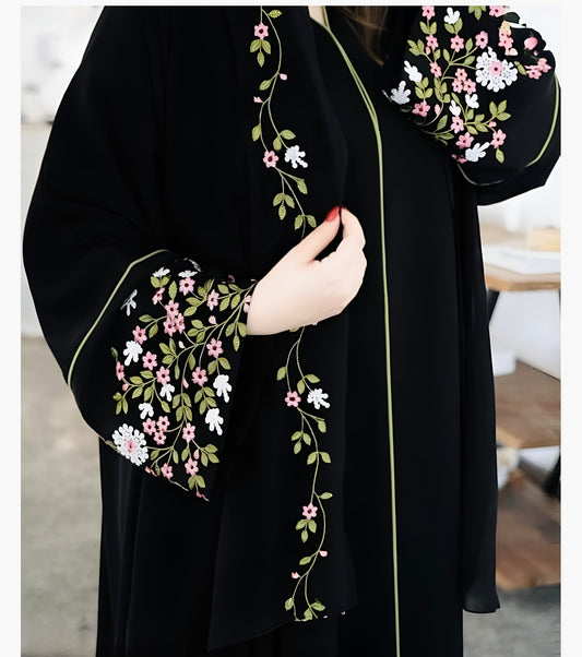 Elegant premium black abaya with colorful floral embroidery showing detailed botanical motifs and roses for modest Islamic fashion