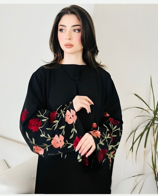 Premium luxury black abaya with colorful floral embroidery worn by model showcasing elegant Islamic dress for special occasions