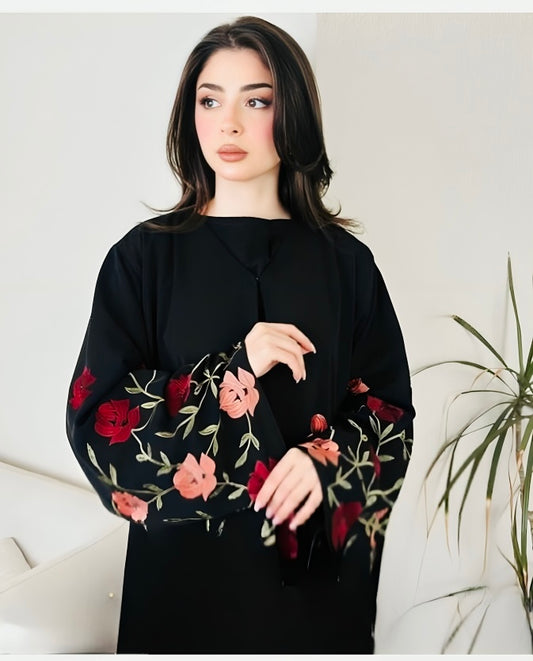 Premium luxury black abaya with colorful floral embroidery worn by model showcasing elegant Islamic dress for special occasions